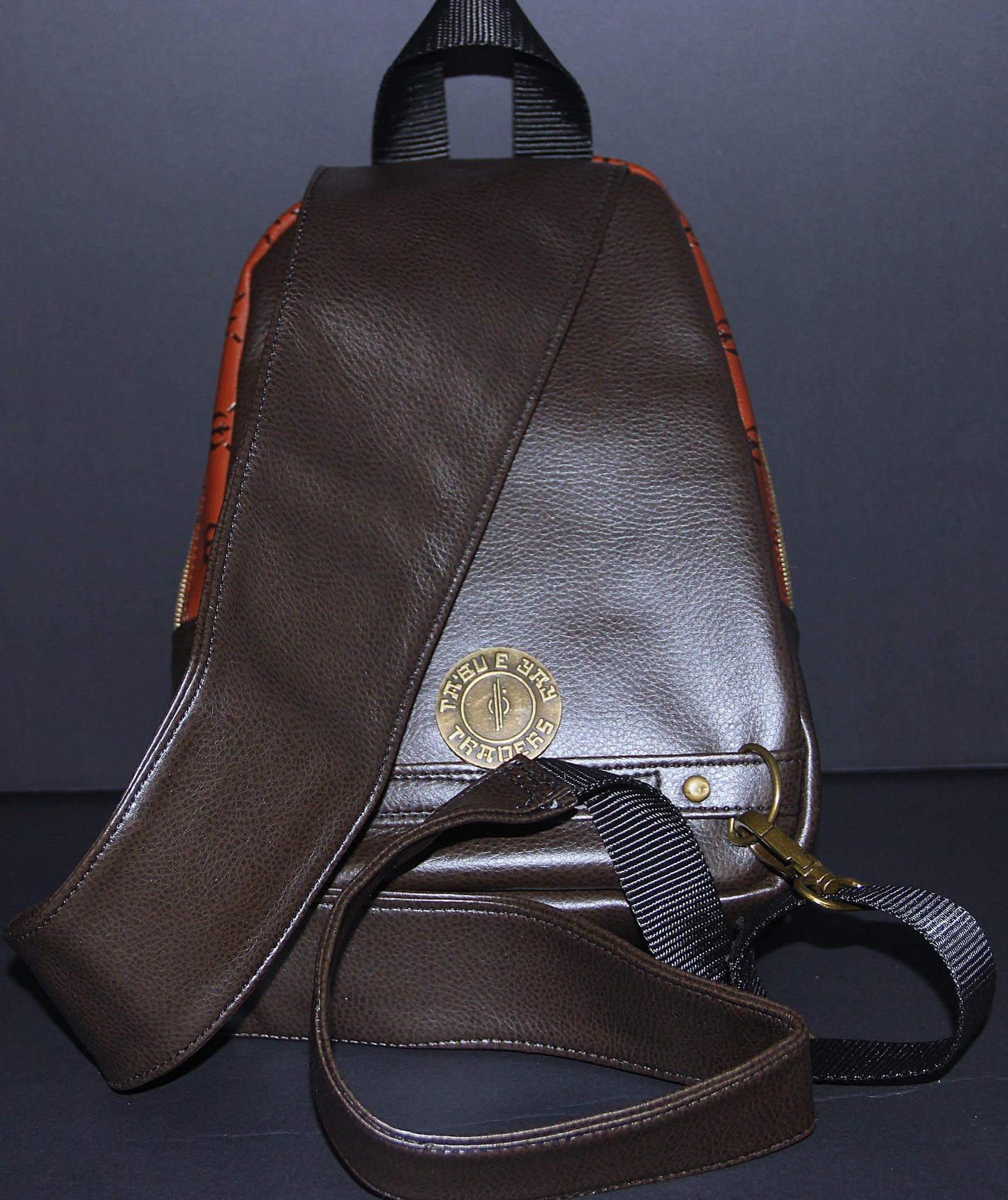 Scoundrel Symbol Medallion featured on Brown on Dark Brown Debossed Quilted Look Faux Leather Unisex Sling Bag
